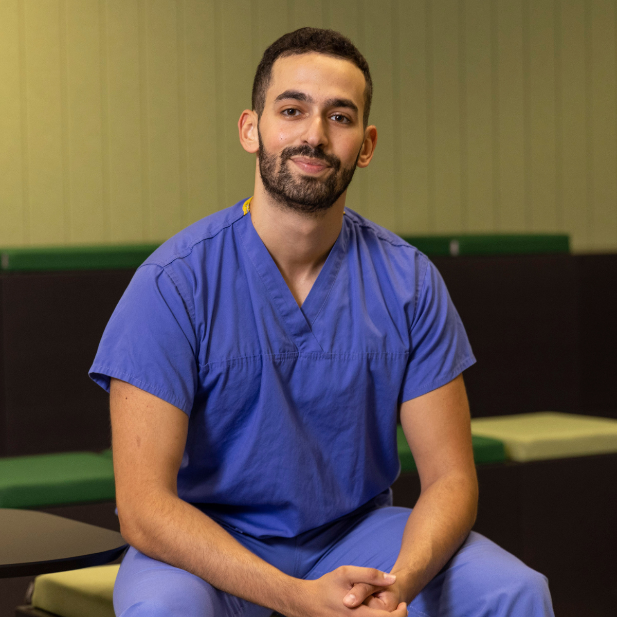 Portrait of Yusuf Ben-Tarif wearing medical scrubs